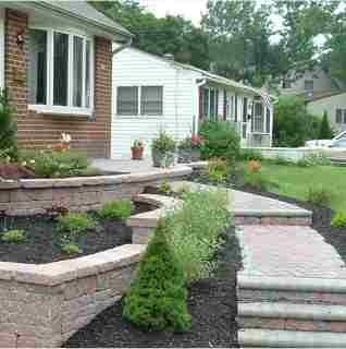 Stone retaining wall built by masonry contractors in Newtown