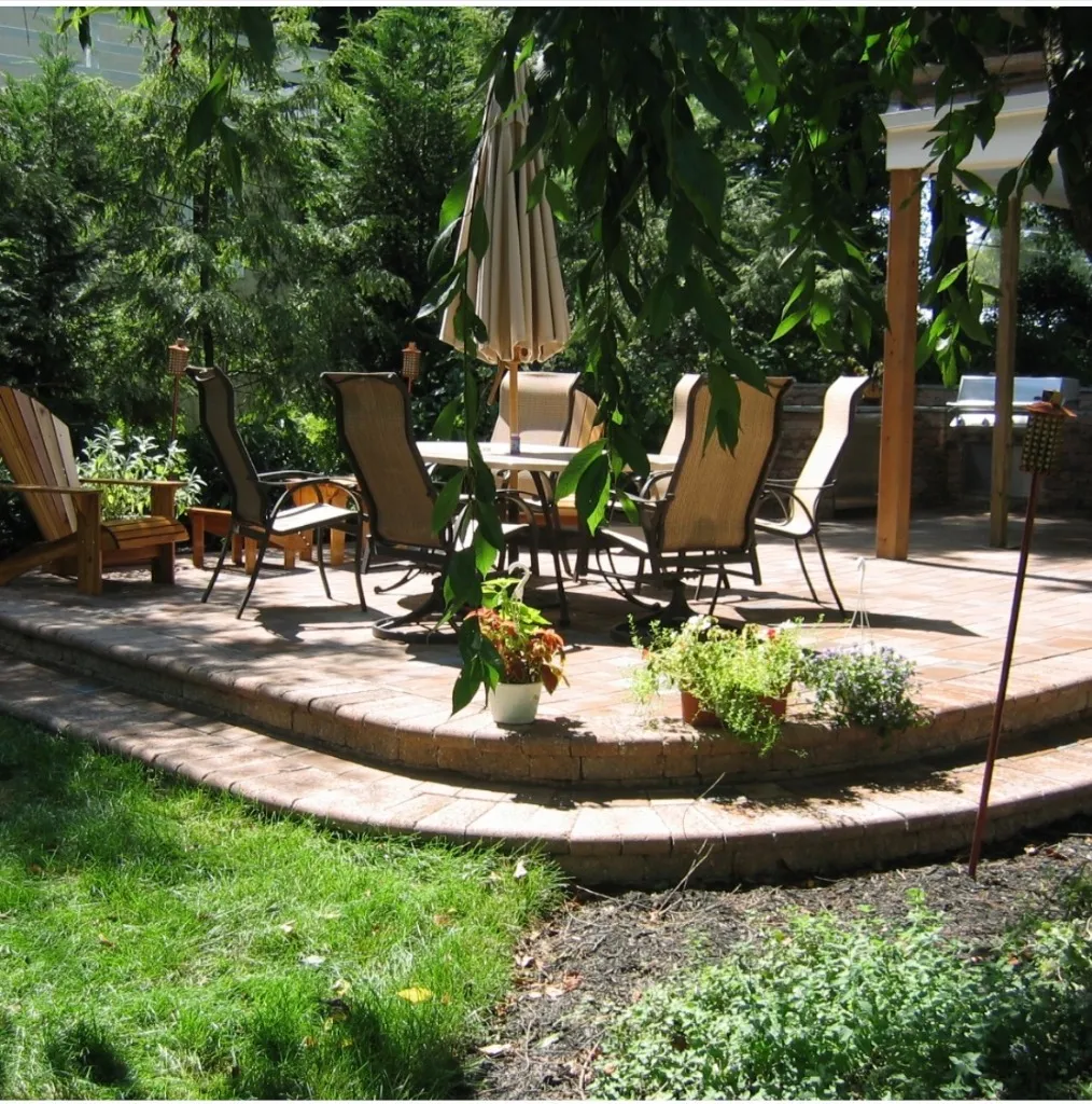 Custom outdoor kitchen and dining area with pergola in Richboro PA by Northampton Nursery