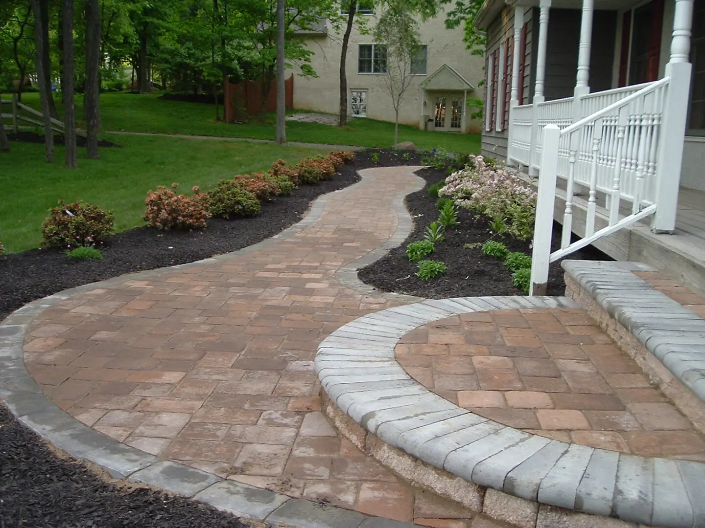 Brick walkway leading to porch steps.